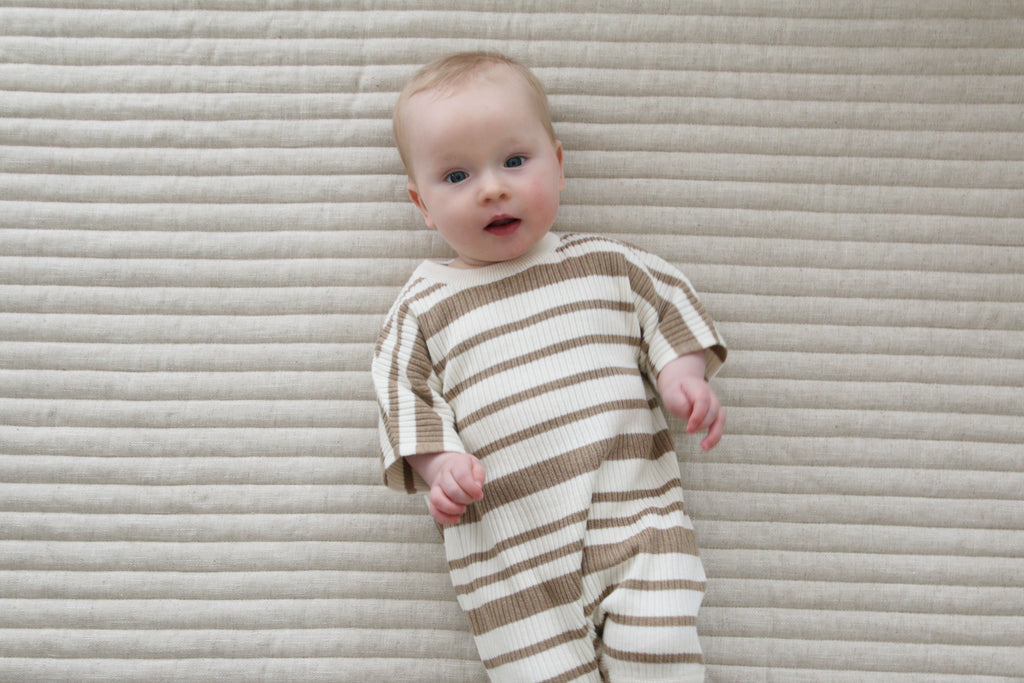 Baby on a quilted play mat