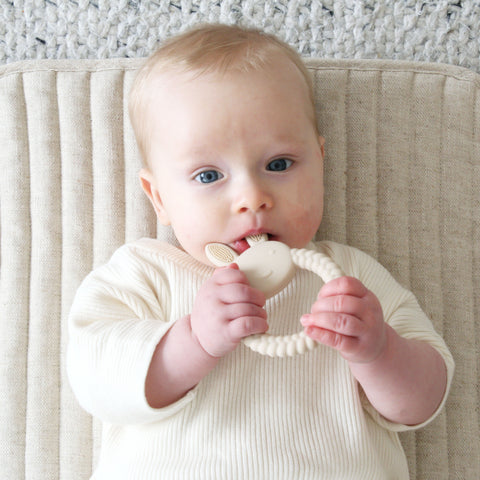 A baby chewing on a bunny teether